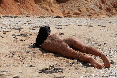 Blue eyed chick playfully posing naked in the dessert