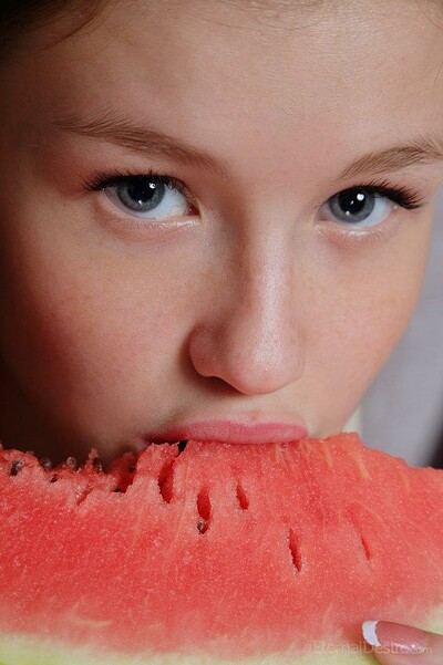 Young teen enjoys watermelon and caresses her naked body with the fruit