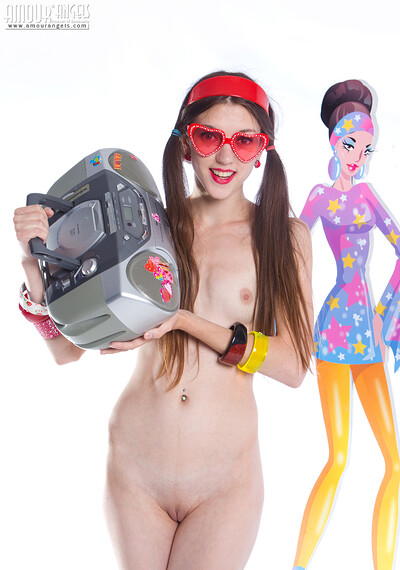 Gorgeous teen girl Sunny with red heart glasses posing with tape recorder