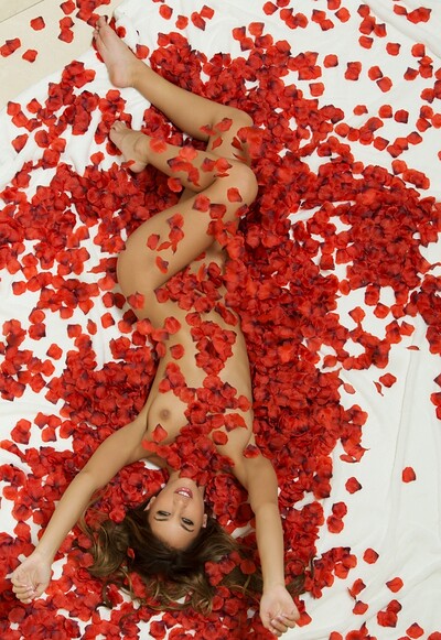 Gorgeous model Uma Jolie sensually poses as she lays naked covered in rose petals