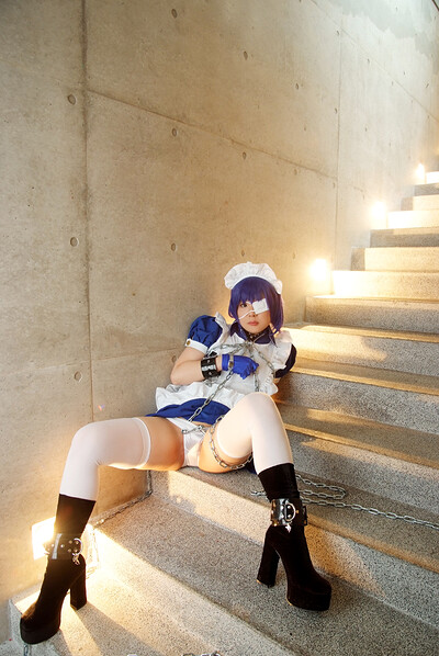 Naughty cosplay babe feels kinky with the chains on the stairs