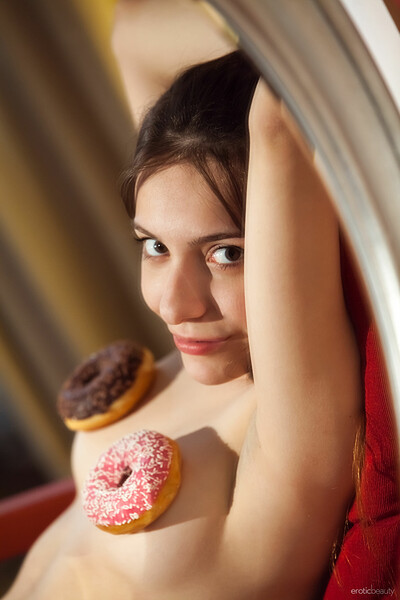 Adorable Maxima eats donuts and shows off her tight ass and trimmed pussy