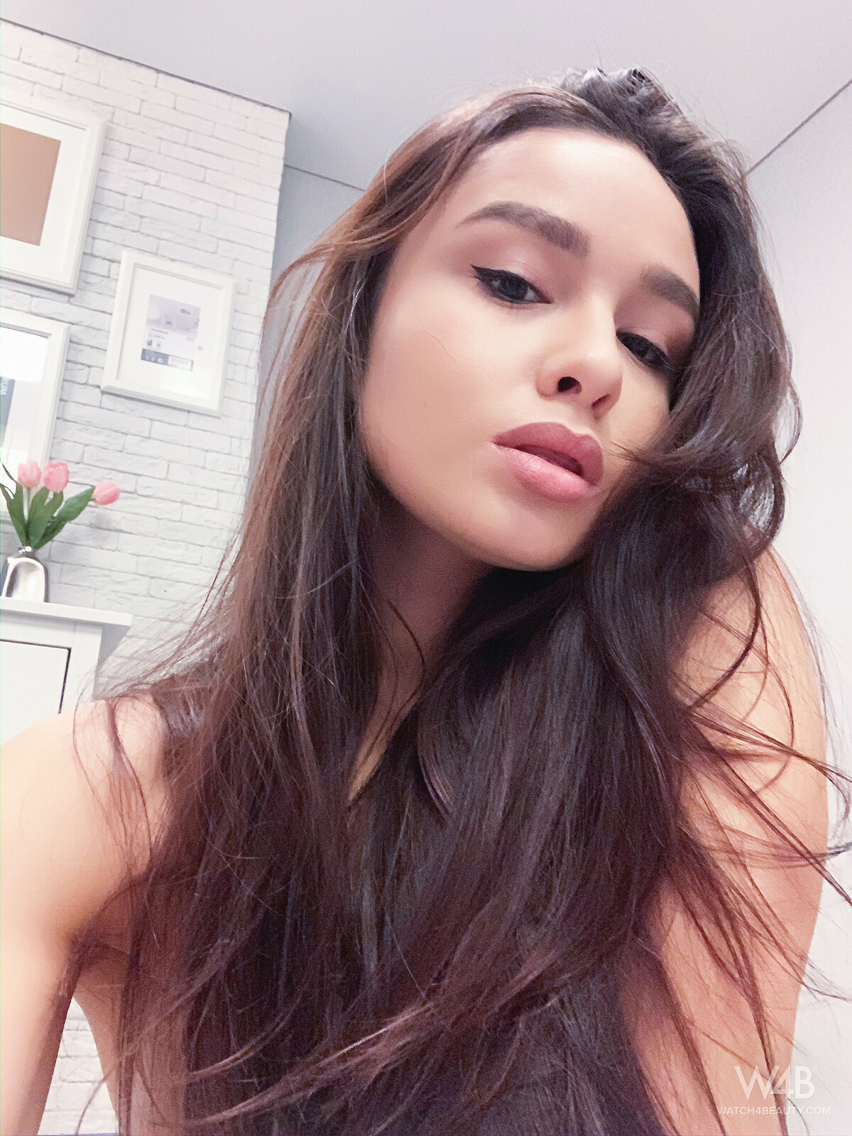 Beautiful model is taking selfies so we can see the beauty of her natural body