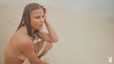 A magnificent babe with braids enjoys her day at the beach in nude