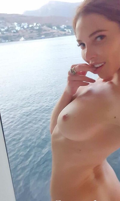 Flirty Russian redhead exposing her perky tits as she takes selfie shots
