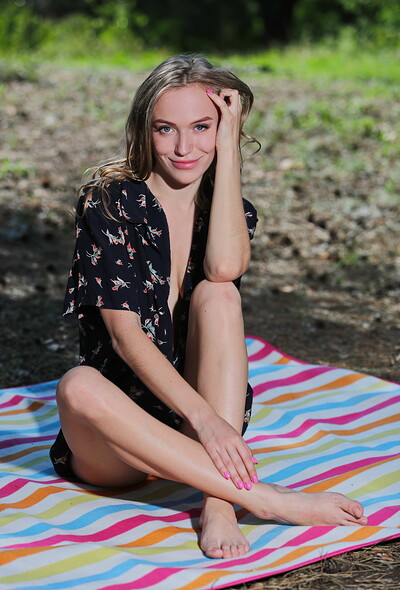Aislin looks stunning while posing naked on her blanket outdoor
