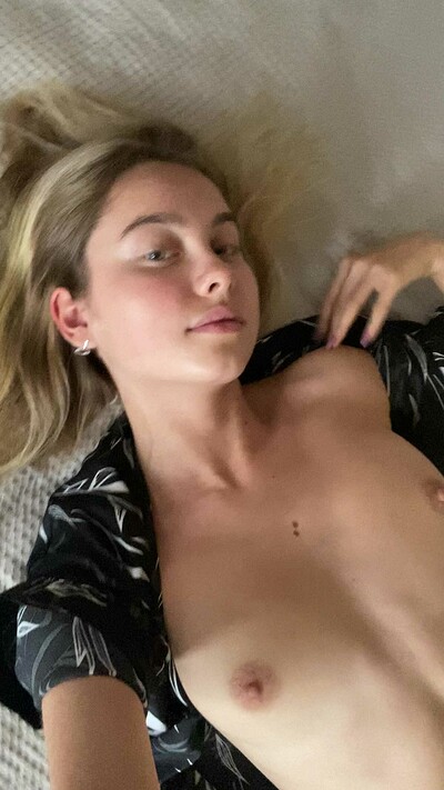 Russian doll Sophia Blum is not shy to show her cute small boobs as she poses on the bed