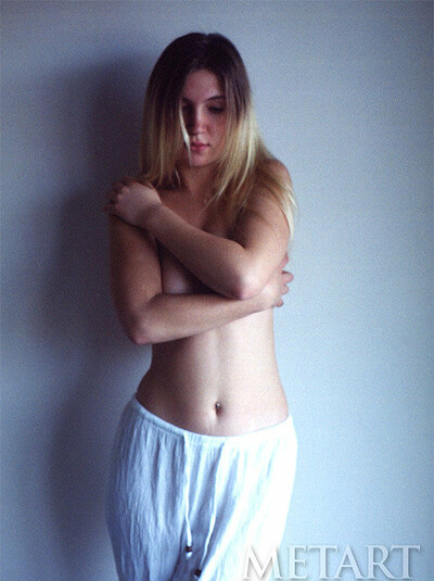 Petite blonde chick posing in a sheer white dress