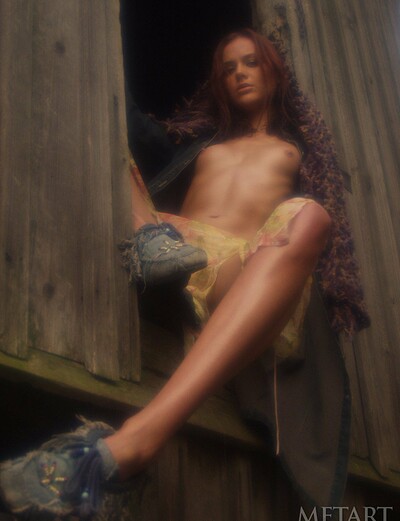 Redhead beauty runs her farm topless and aroused