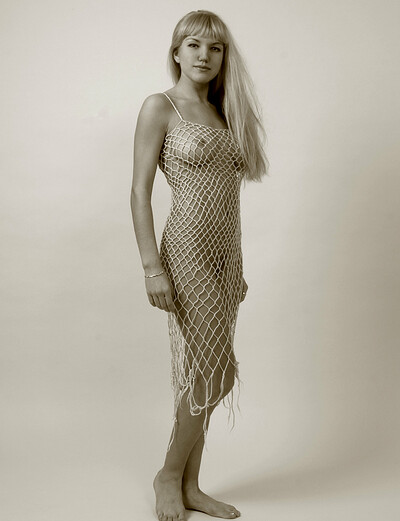 Playful doll Ingret A wears fishnet dress for the camera