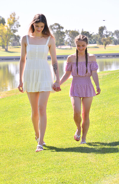 Graceful ftv models Mira and Olivia enjoying a sunny day together as they kiss and walk outdoors