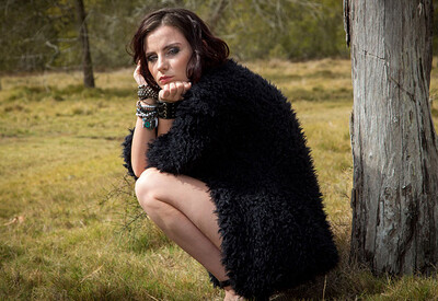 Outstanding brunette teasingly unveils her torso and bottom during an outdoor photo session