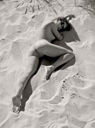 Tanning on the beach for Mia involves lots of nudity and posing