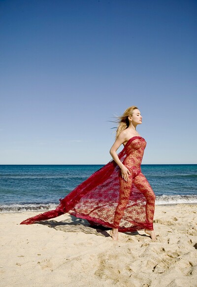 A veil gently caresses Lia May as she dances on the beach