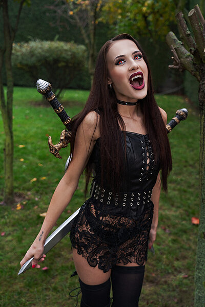Cosplaying hottie shows off her meaty muff and nice tits while posing as a devilishly horny vampire from Skyrim
