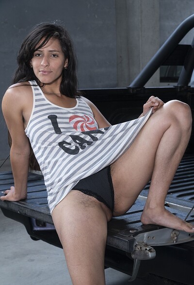 Pamela in Pamela poses naked on her black truck from We Are Hairy