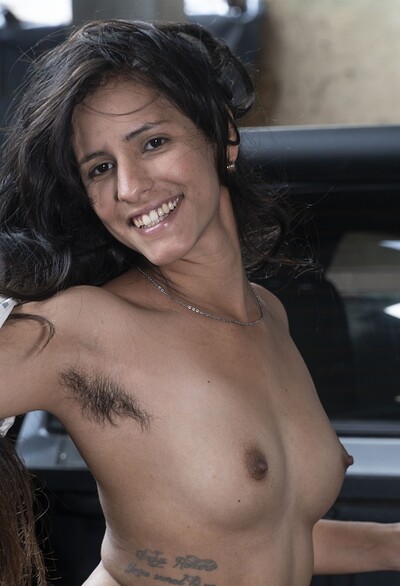 Pamela in Pamela poses naked on her black truck from We Are Hairy