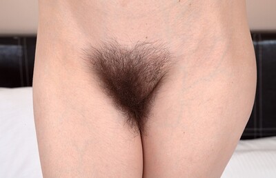 Esme in Esme wears green as she strips naked in bed from We Are Hairy