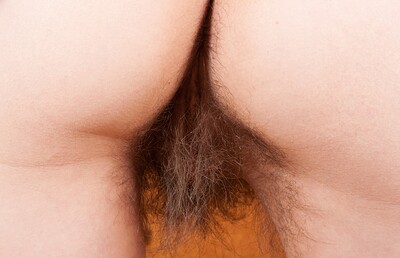 Cara Banx in Cara Banx strips naked by her book shelf from We Are Hairy
