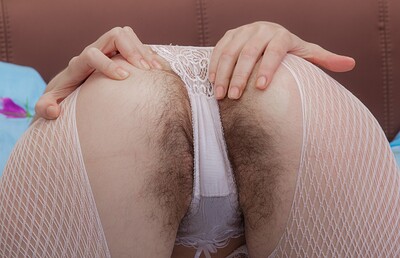 Lima in Lima strips from lingerie and stockings on her bed from We Are Hairy