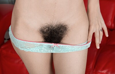 Luna O in Luna O strips naked on her red couch from We Are Hairy