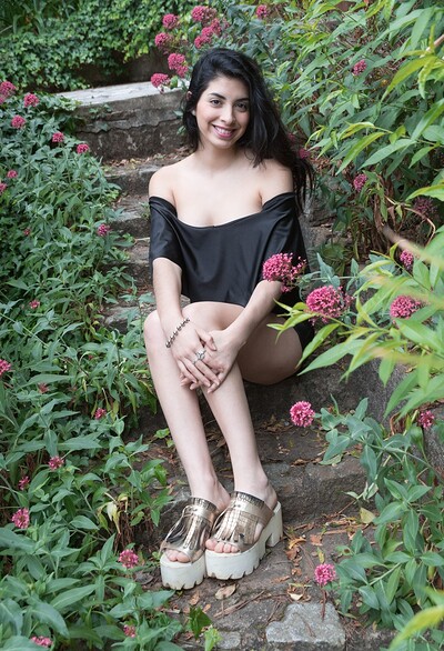 Ornella in Ornella strips outdoors with a sexy rose in hand from We Are Hairy