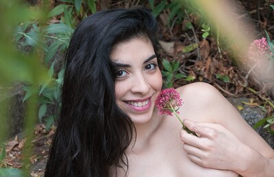 Ornella in Ornella strips outdoors with a sexy rose in hand from We Are Hairy