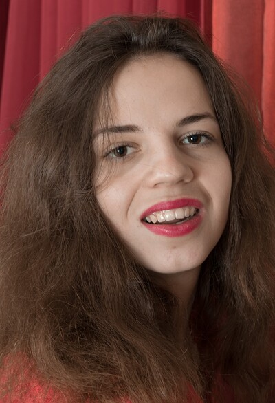Fiorella in Fiorella strips naked on her red bed with ease from We Are Hairy