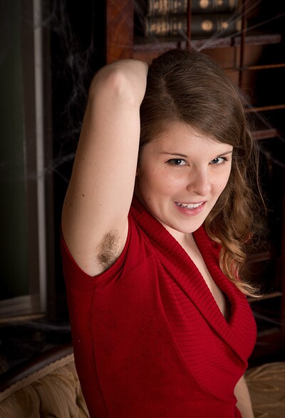 Jada in Jada slides off her red dress on her sofa from We Are Hairy