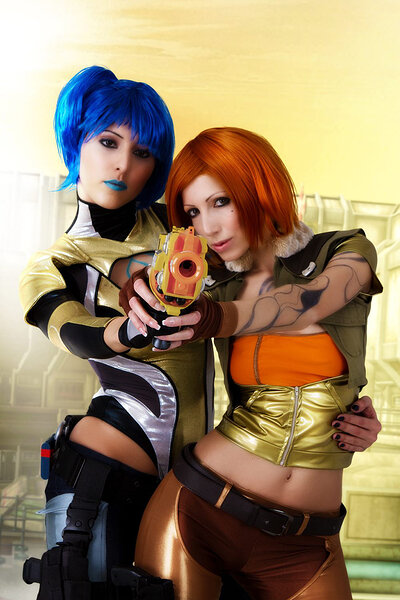 Short haired dolls Anne and Angela captivatingly cuddling as they cosplay as Lilith and Maya from the Borderlands series