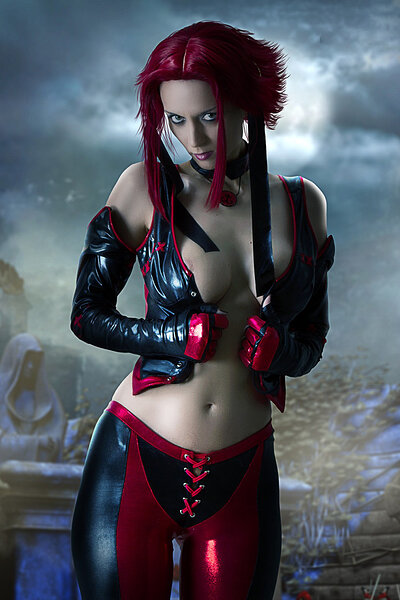 Red haired Lana posing as Agent Bloodrayne as she alluringly unveils her nicely gifted breasts