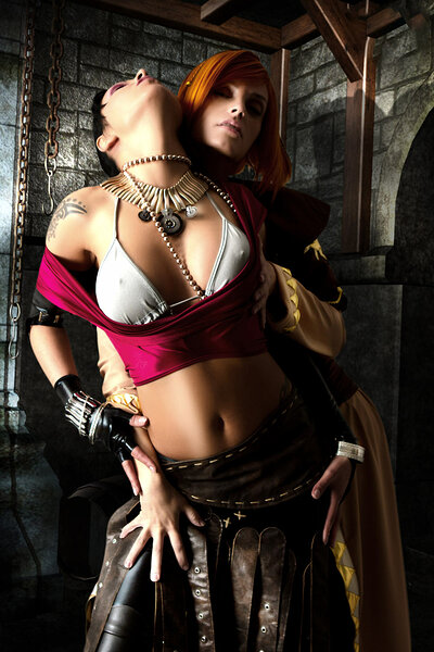 Two feisty and gorgeous vixens cosplay as Dargon Age gals in the dungeon as they take off each other's clothes and play with their amazing breasts