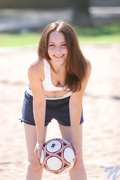 The babe's outdoors in brief duds, pounding a soccer ball on the volly court - hella funny!