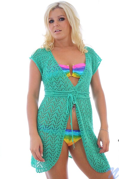 Erin, smokin' and stackin', flaunts her vibrant swimsuit.