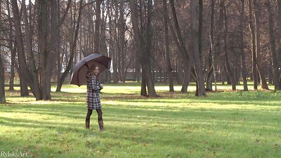 The cute blonde teen poses seductively in the September rain before going to the shooting to take off everything and pose naked.
