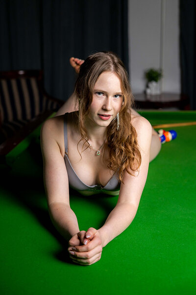 The endearing gal flaunts her curvaceous body on the pool table, slipping out of her lingerie to expose her bare pussy and asshole.
