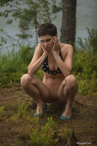 Diana strips off her bikini and high heels in the forest, revealing her firm tits and skinny body.