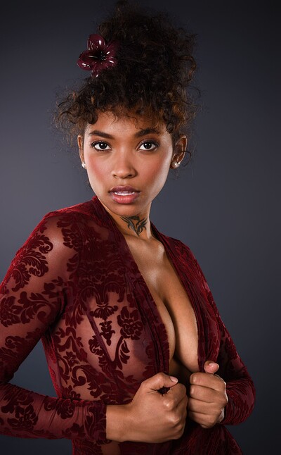 Barbie Rous, in a crimson lacy bodystocking, strips it off and shoves her dildo deep inside herself.