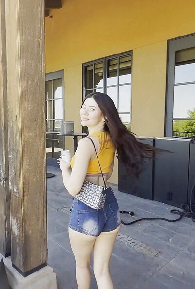 Lovely Zoey's petite-framed body is filmed as she playfully exhibits her booty in sexy denim shorts, posing in public.