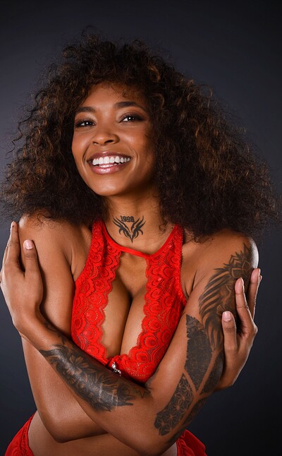 Barbie Rous's oiled-up body glistens as she slowly peels off her red lingerie, revealing her slick, naked curves.