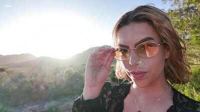 Sally Hunter squats in the lee of the wind, shoving a glass dildo into her pink pussy before suddenly pissing all over her phone as she films a selfie video.