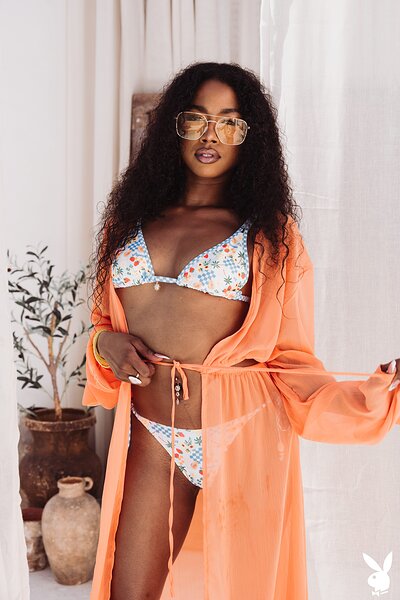 The stunning babe, wrapped in a breezy coral cover-up over a playful patterned bikini, is being fucked hard.