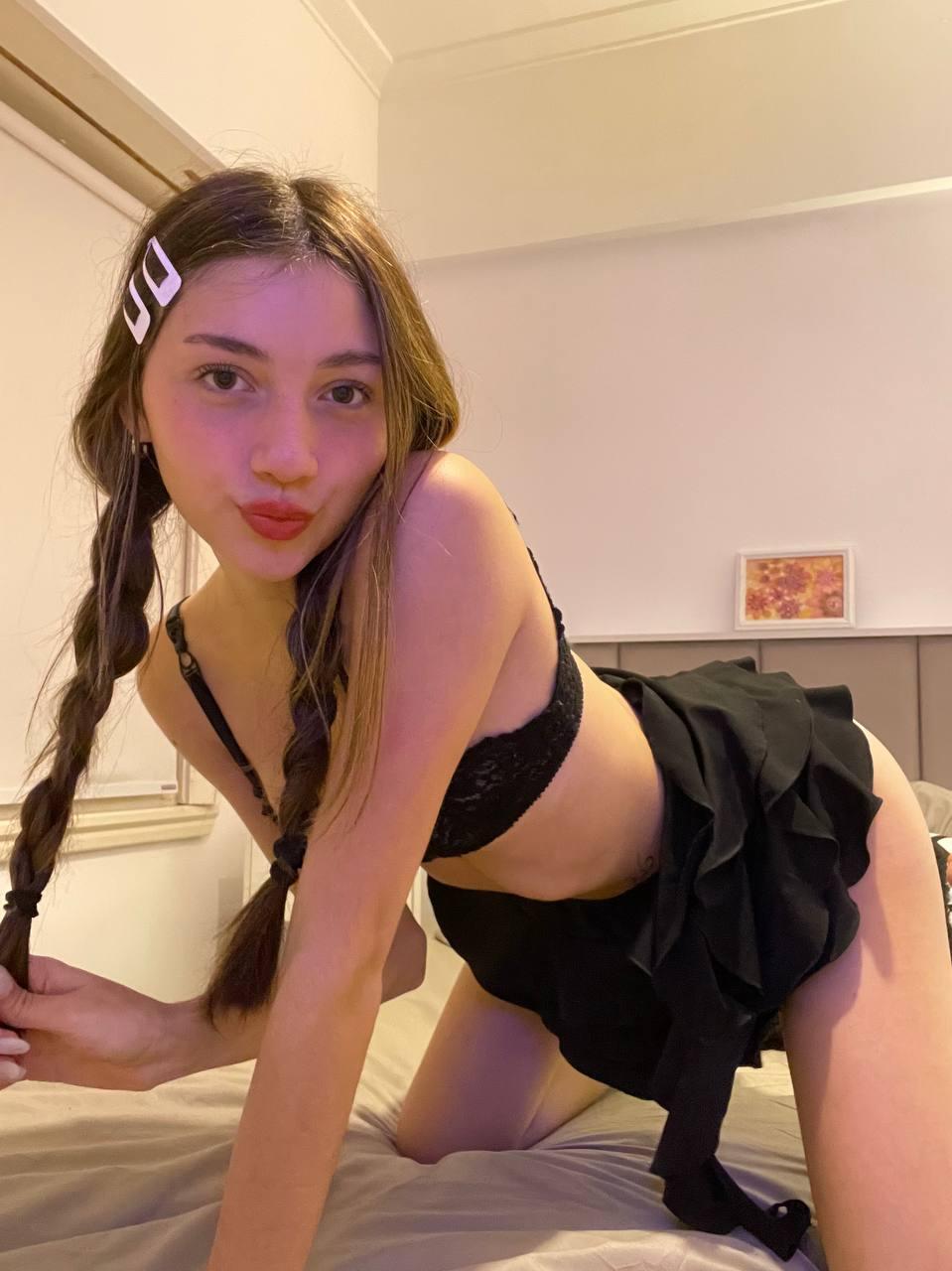 Kiera Brooks, on all fours, wearing black lingerie, her long braid teasing, lips puckered, ready to take you.