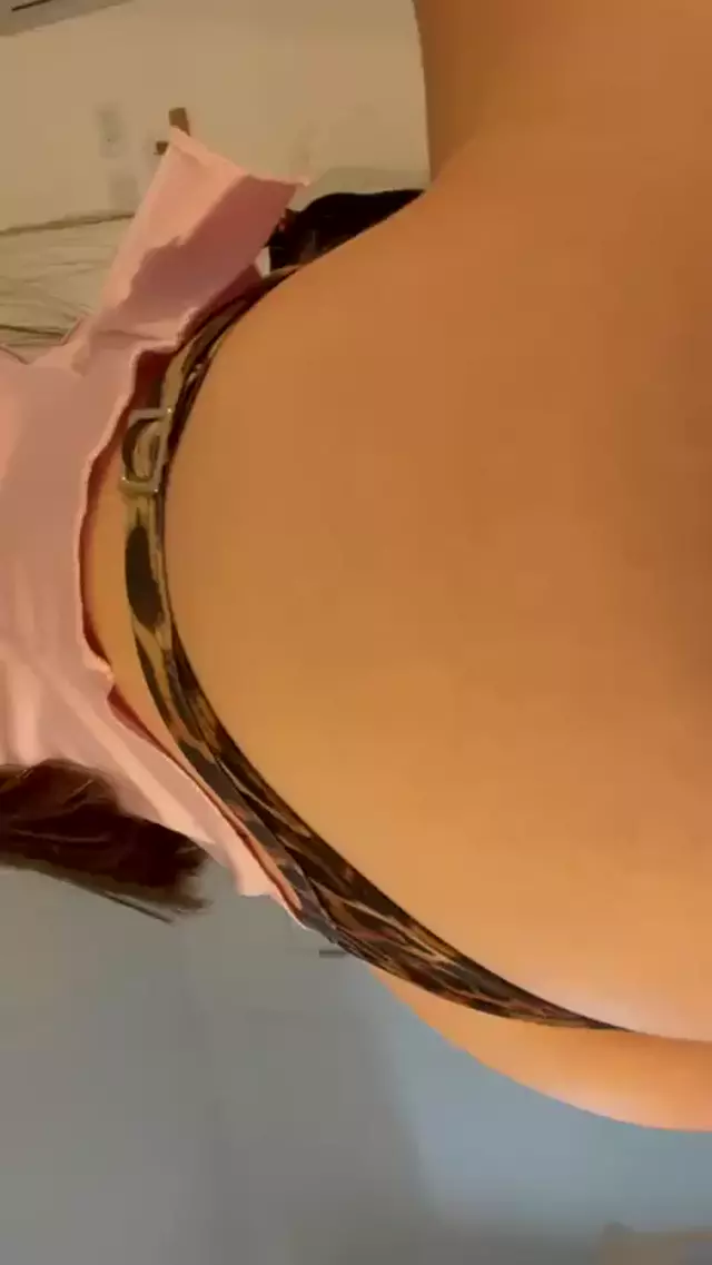 Kiera Brooks's hand pulls down her leopard-print thong, revealing her smooth, tan, curvy ass, teasing her own pleasure.