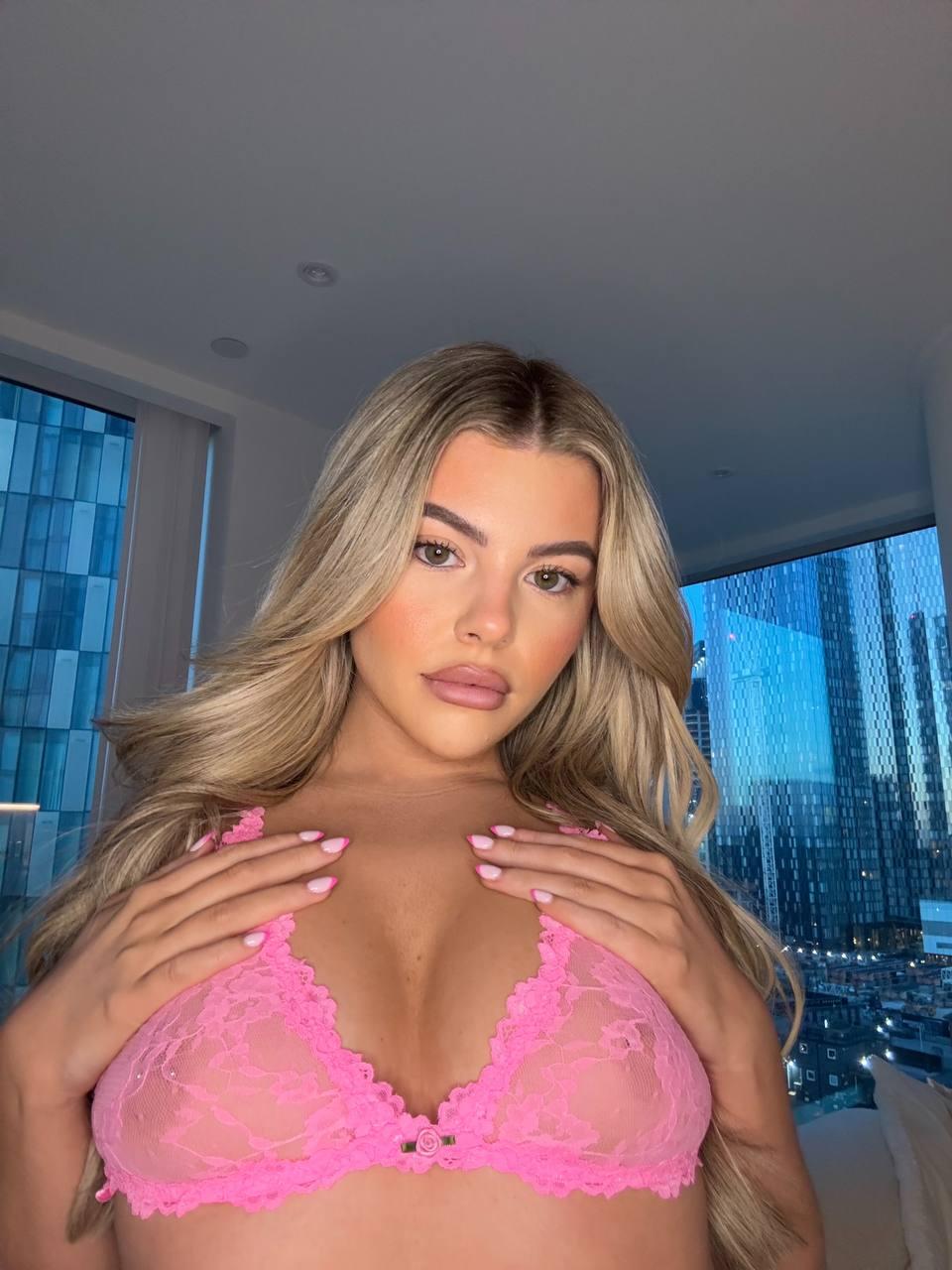 Tilly Harrington's hands tease her pink lace bra, her nipples pressing against the fabric, feeling so damn sexy.