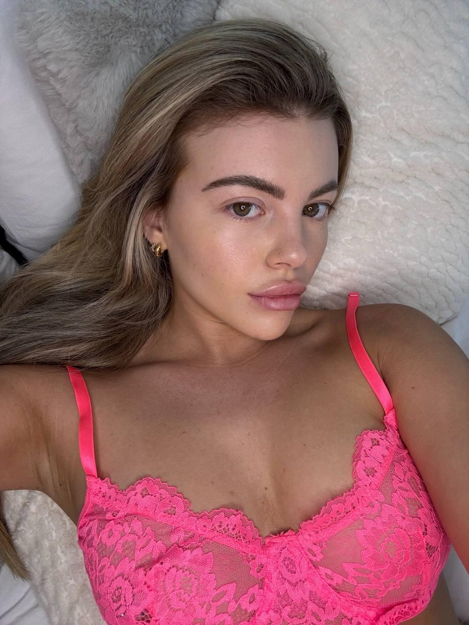 Tilly Harrington's pink lace bra is teasing, her eyes are already on you, feeling the heat.