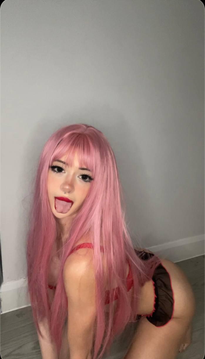Mimi's pink hair, tongue out, arching back, red lingerie, and bare ass, ready for a wild, intense fuck session.