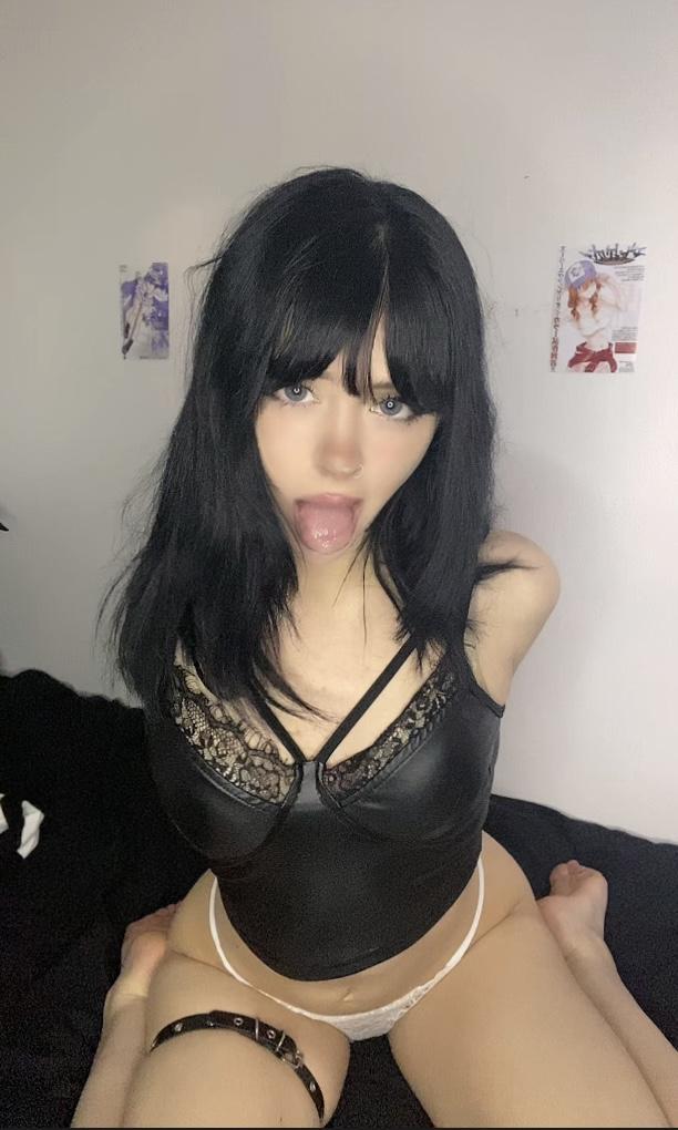 Mimi's tongue is out, her black hair frames her face, her lace panties are teasing her wet pussy.