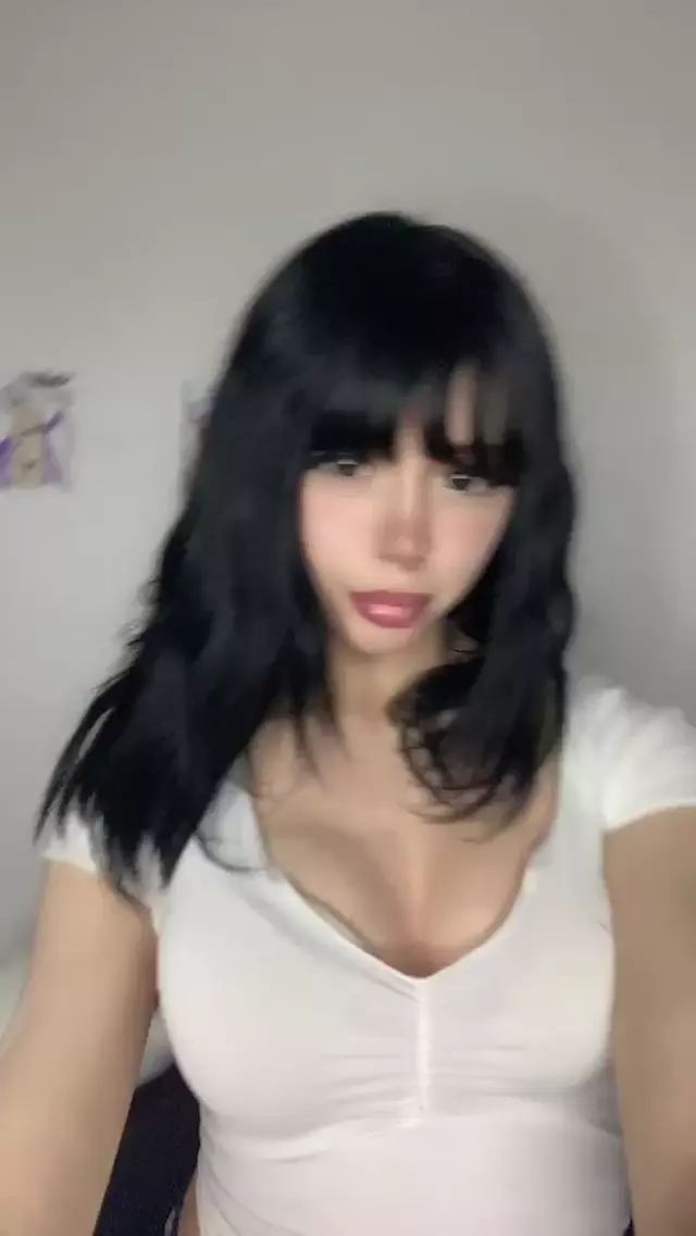 Mimi's black hair frames her face, her cleavage pressing against her tight white top, feeling so sexy.