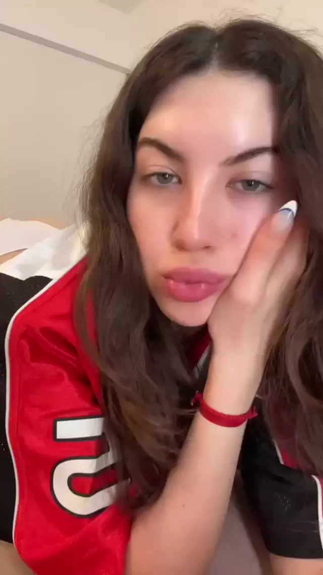 Amber James's plump lips are parted, her white nails teasing her cheek, ready for a kiss.